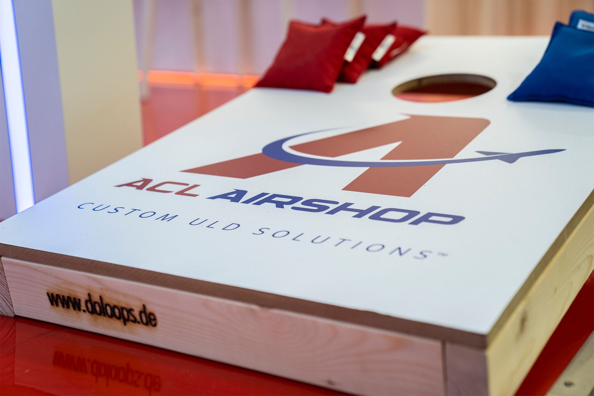 Cornhole board game with ACL Airshop logo