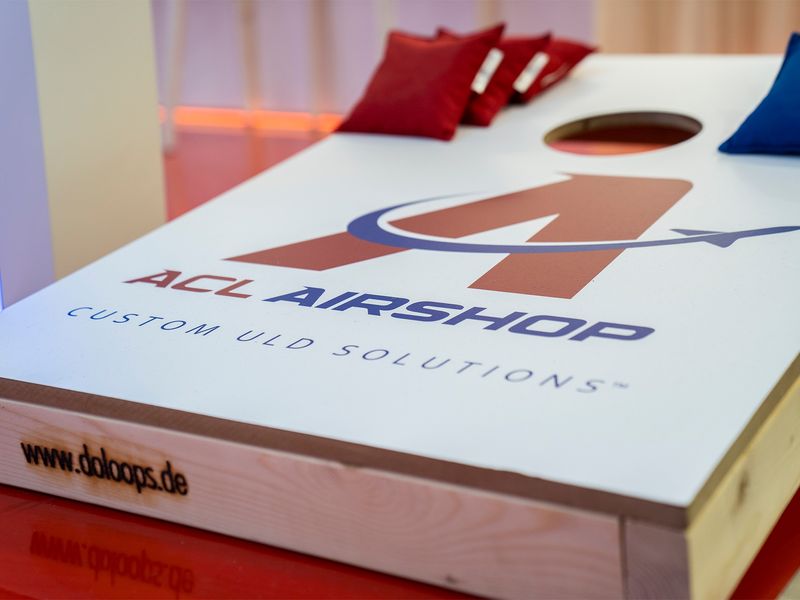 Cornhole board game with ACL Airshop logo